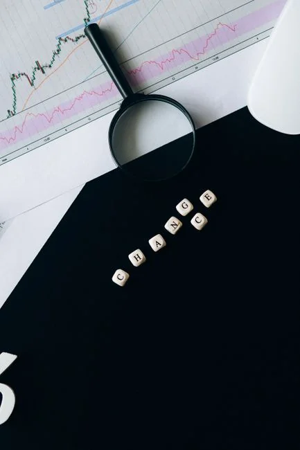 Flat lay of keyboard letter tiles spelling email on coral backdrop.